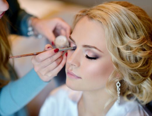 Wedding makeup artist making a make up for bride