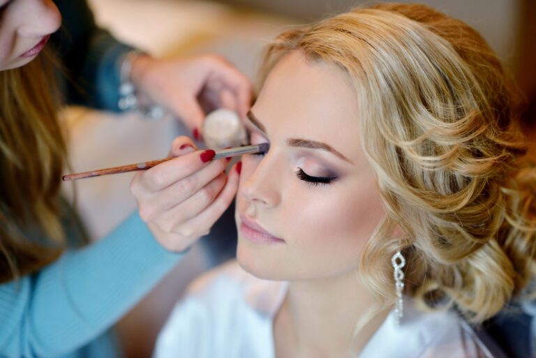 Wedding makeup artist making a make up for bride